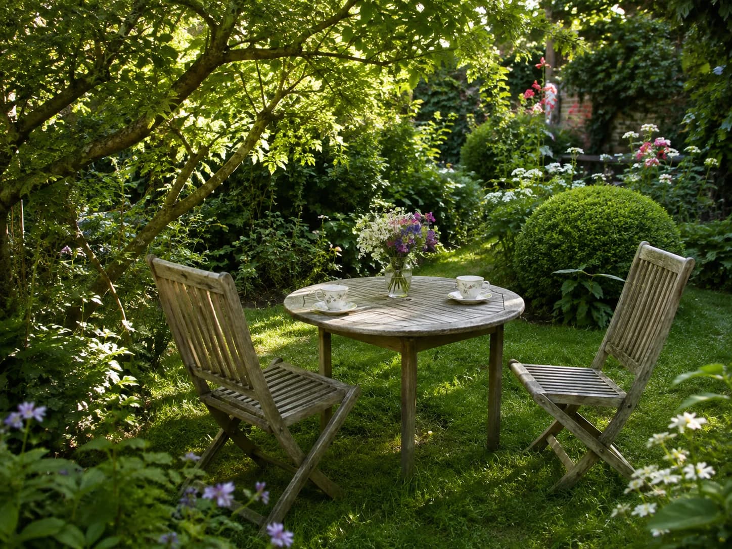A sunny garden with a table set for tea